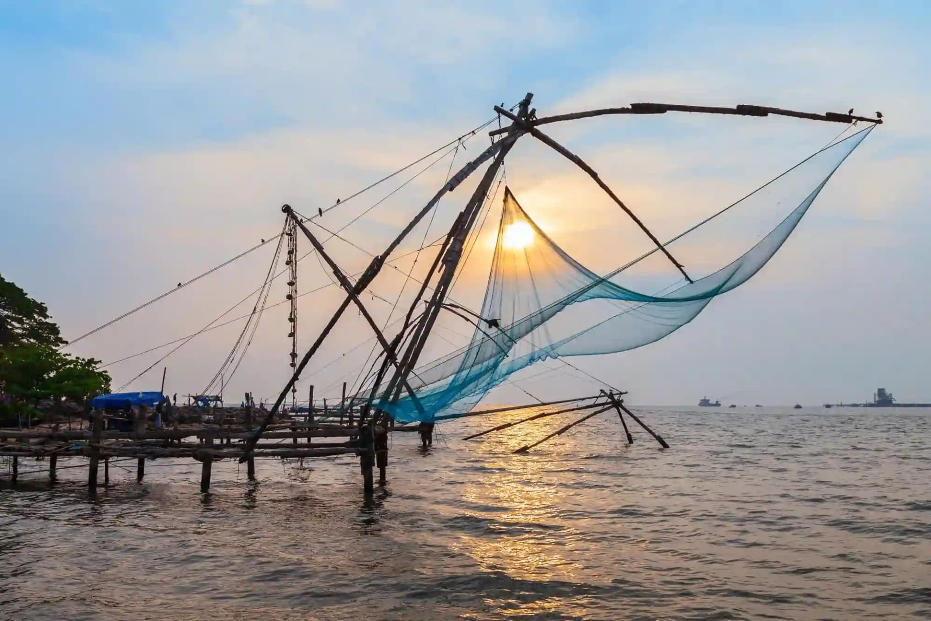 Kerala tour package sightseeing at the Chinese fishing nets in Fort Kochi at sunset