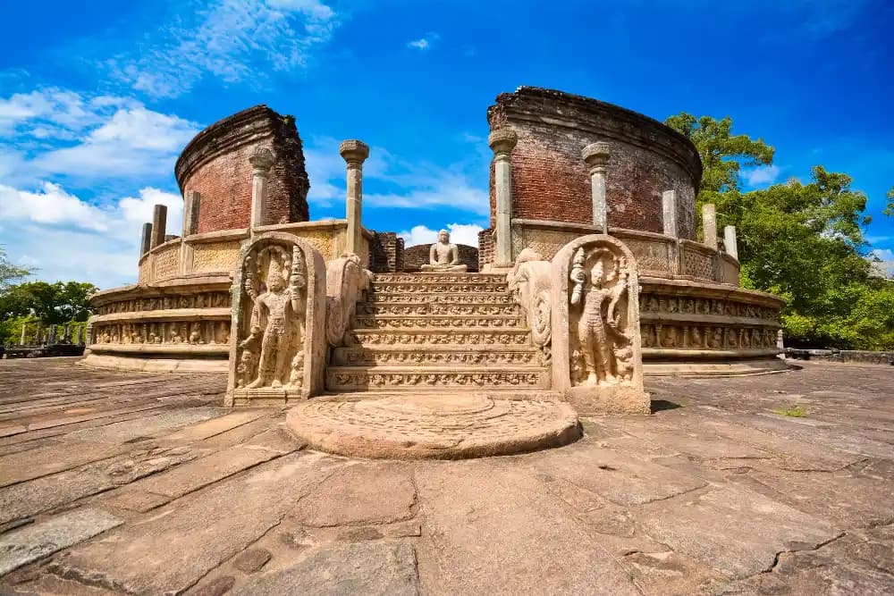 Polonnaruwa Vatadage with carved guardstones and a seated Buddha in the ancient city of Polonnaruwa, Sri Lank