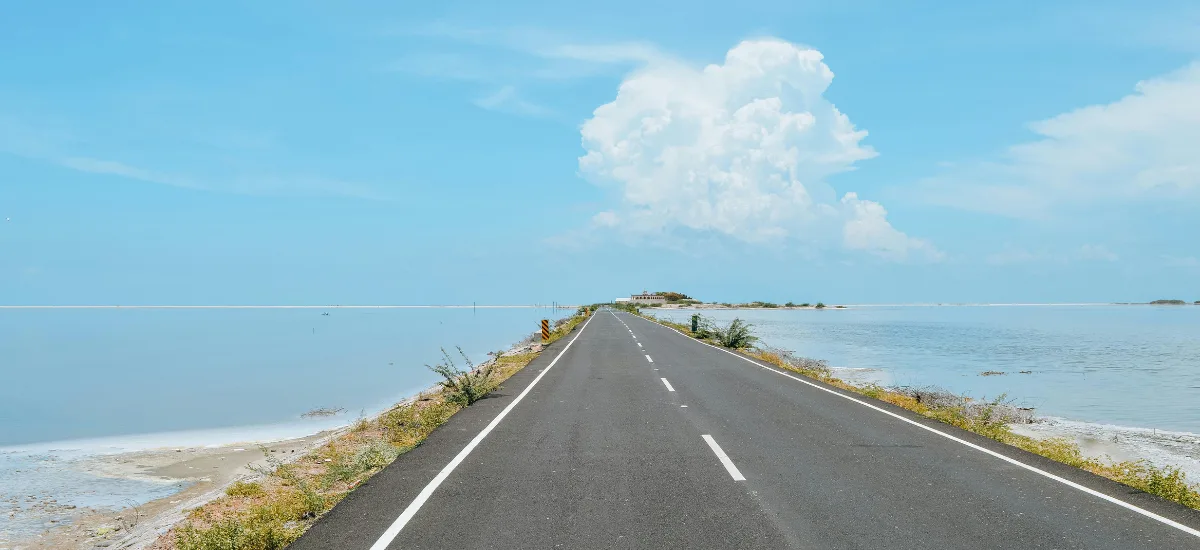 Dhanushkodi Beach near Madurai with clear blue water and long coastal stretch at Rameswaram