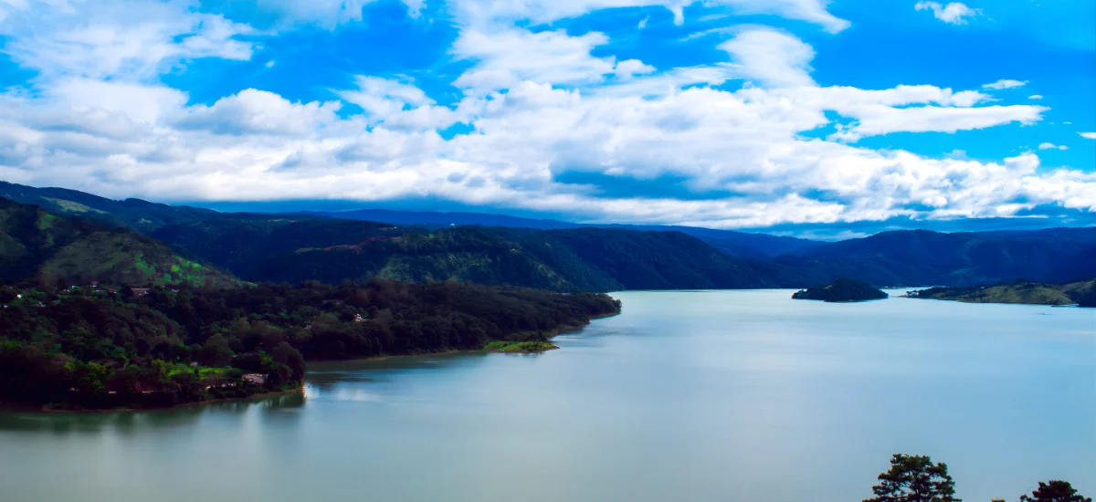 A wide view of the peaceful Umiam Lake in Shillong, which is one of the best places to visit in India in August.